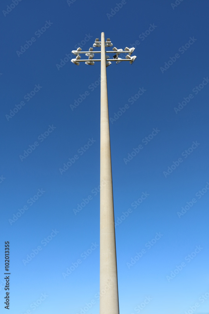 Stark color metallic lamppost against deep blue sky
