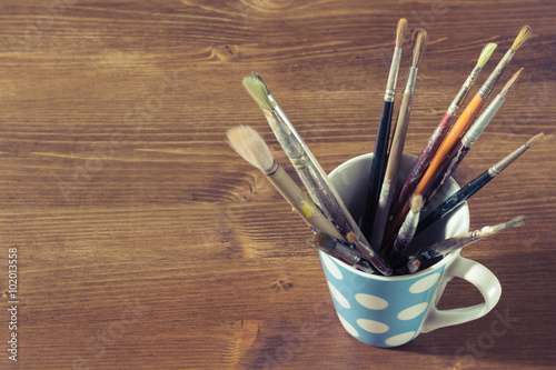 old paintbrushes in a mug or cup