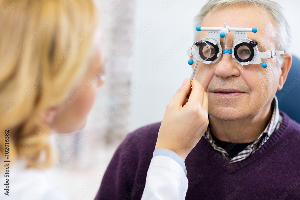 Optical specialists precisely determines diopter to senior patie Optical specialists precisely determines diopter to senior patie