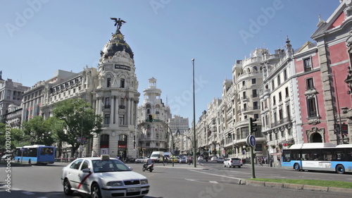Day car traffic near The Metropolis building at Gran Via, famous shopping street known as the Spanish Broadway. photo