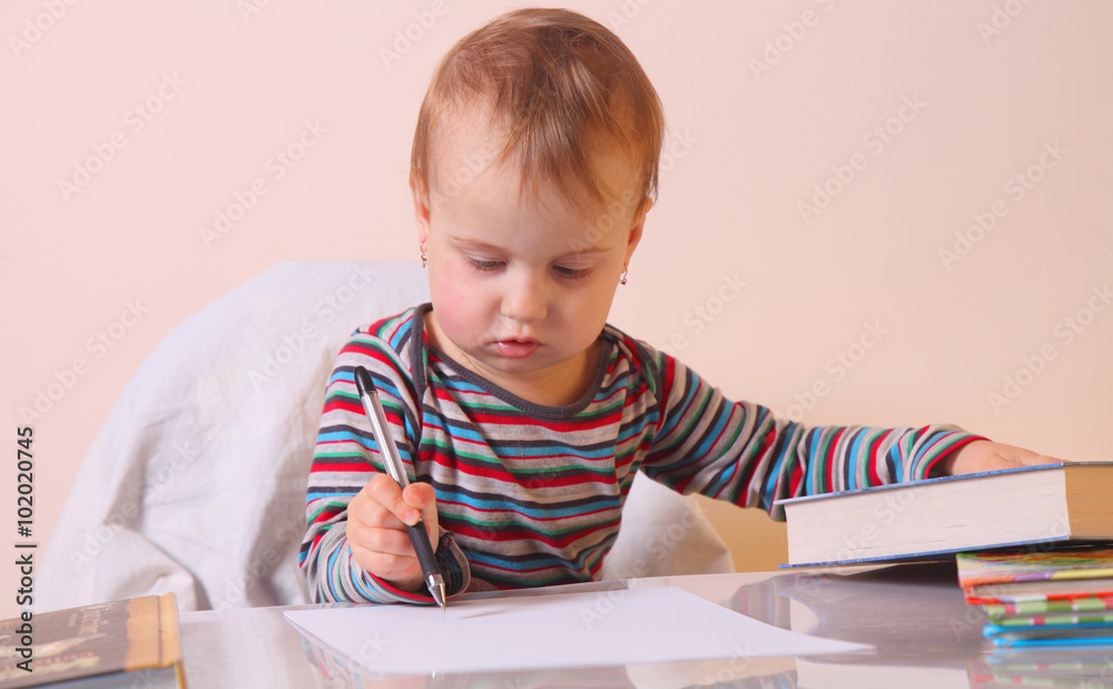 Little beautiful girl writes in notebook Little beautiful girl writes in notebook
