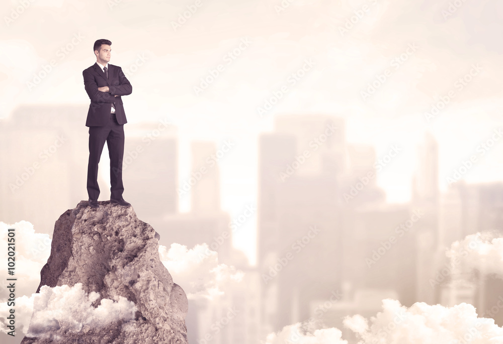 Confident businessman on dangerous cliff Confident businessman on dangerous cliff