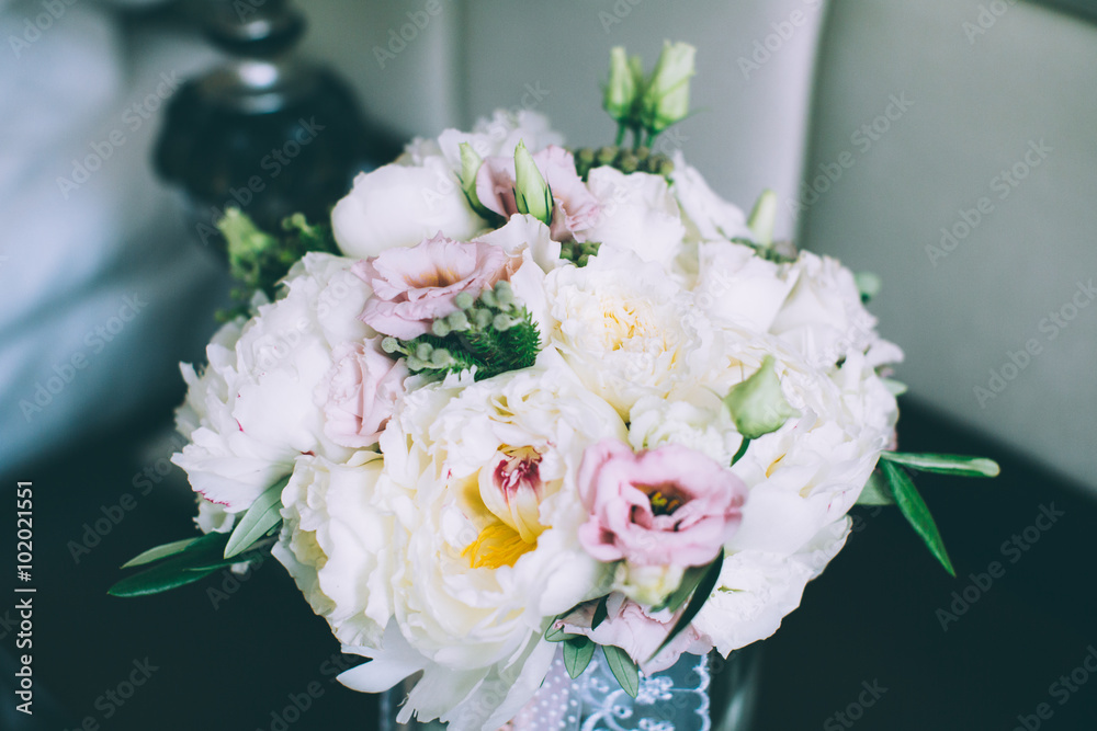 Colorful wedding bouquet in vase in bridal suite