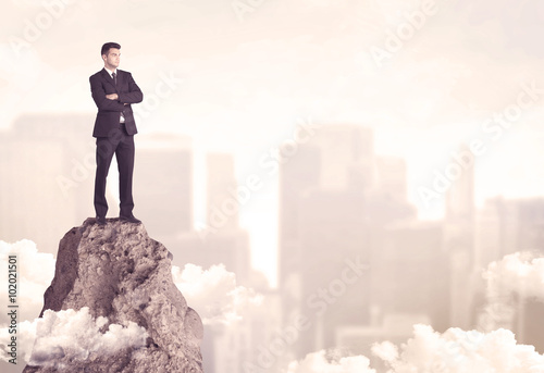 Confident businessman on dangerous cliff
