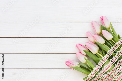 Fototapeta Naklejka Na Ścianę i Meble -  Bouquet of pink tulips on white wooden background. Top view