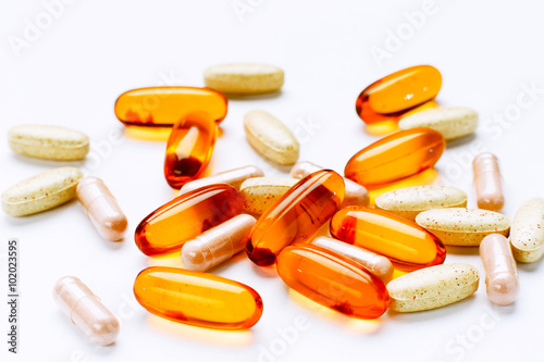 Biological additives to food, vitamins for a healthy lifestyle, capsules an omega 3 with cod-liver oil, transparent orange color an embankment on a light background close up photo