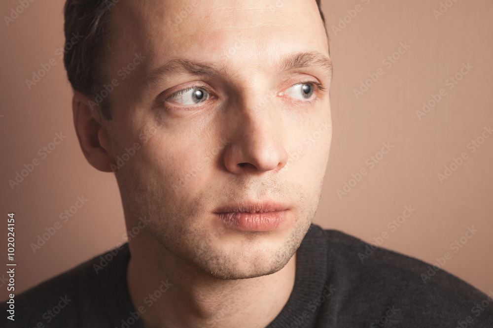 Young handsome positive Caucasian man, close up