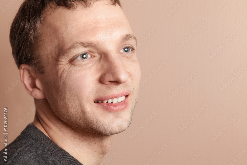 Young smiling handsome man, close up studio portrait Young smiling handsome man, close up studio portrait