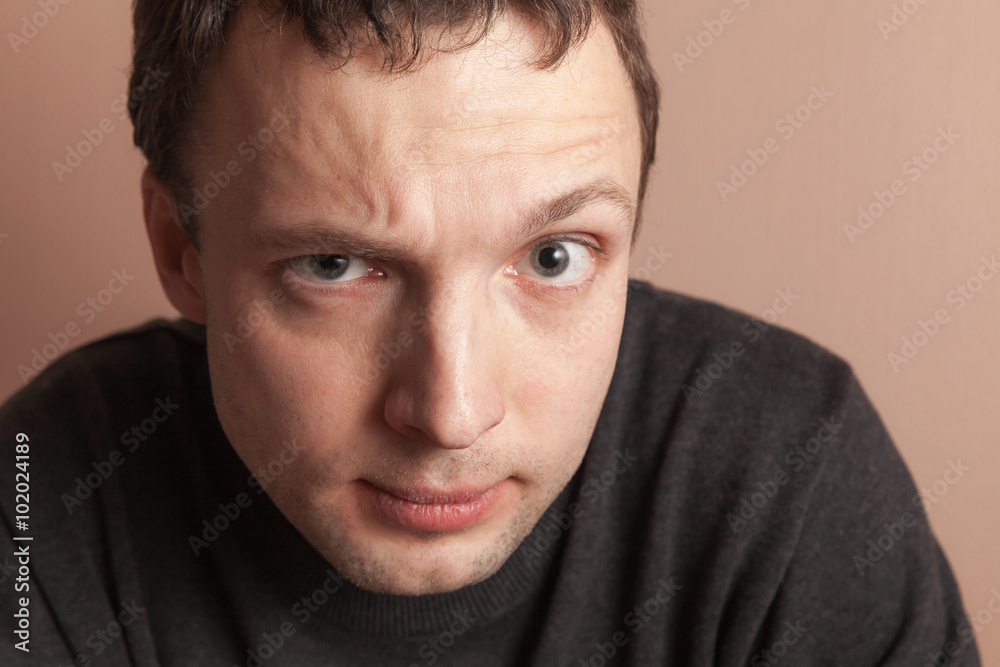 Young serious Caucasian man, close-up studio portrait Young serious Caucasian man, close-up studio portrait