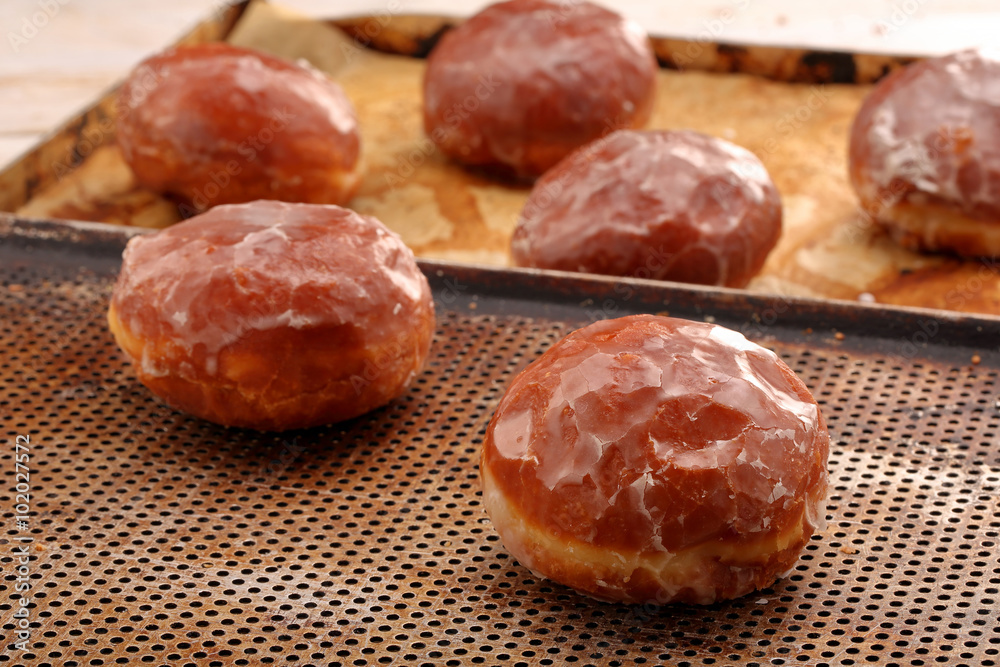 Fresh polish donuts with icing in the bakery