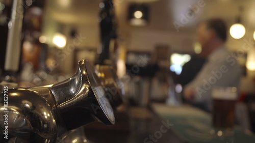 Bartender Pulling A Pint In A British Pub photo