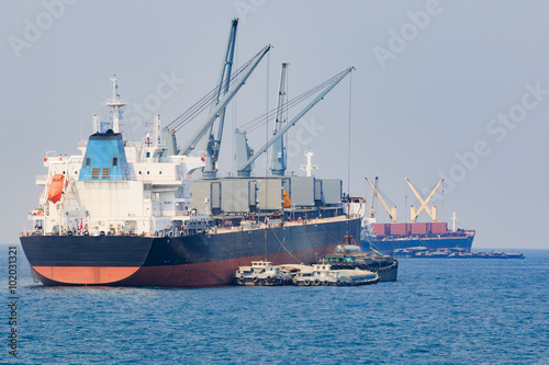 container boat loading goods over clear blue water sea use for v