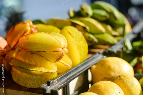 A box of starfruits on a market stall background photo