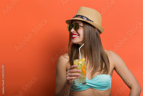 Woman in bikini with a cold drink