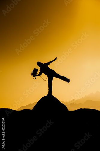 Silhouette of a cameraman at sunset
