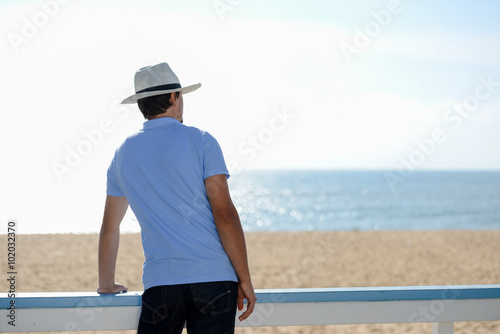 Man standing back view on summer sunny outdoors background