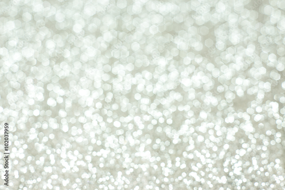 Silver festive glitter bokeh background with defocused Silver festive glitter bokeh background with defocused