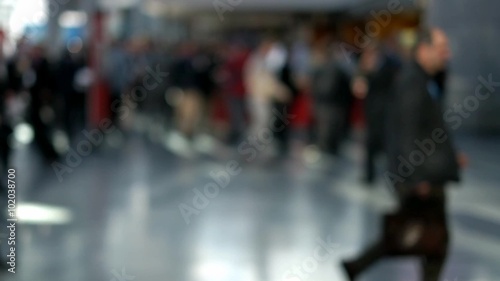 Out of focus shot of people walking about in a street