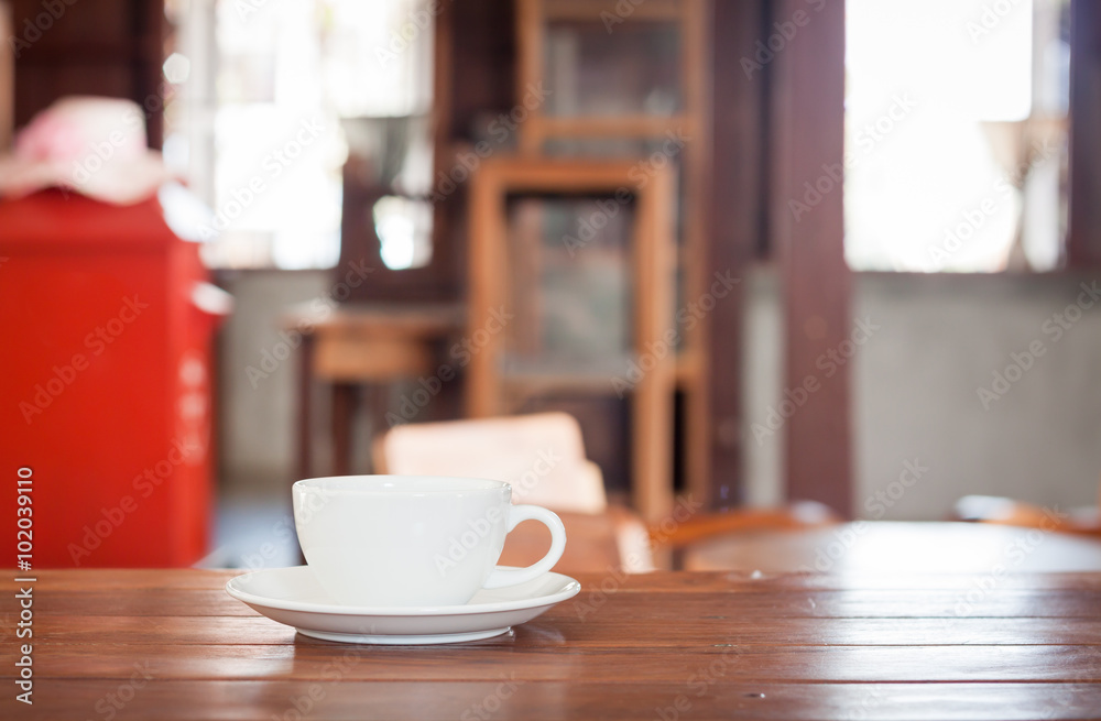 White coffee cup on wooden table White coffee cup on wooden table