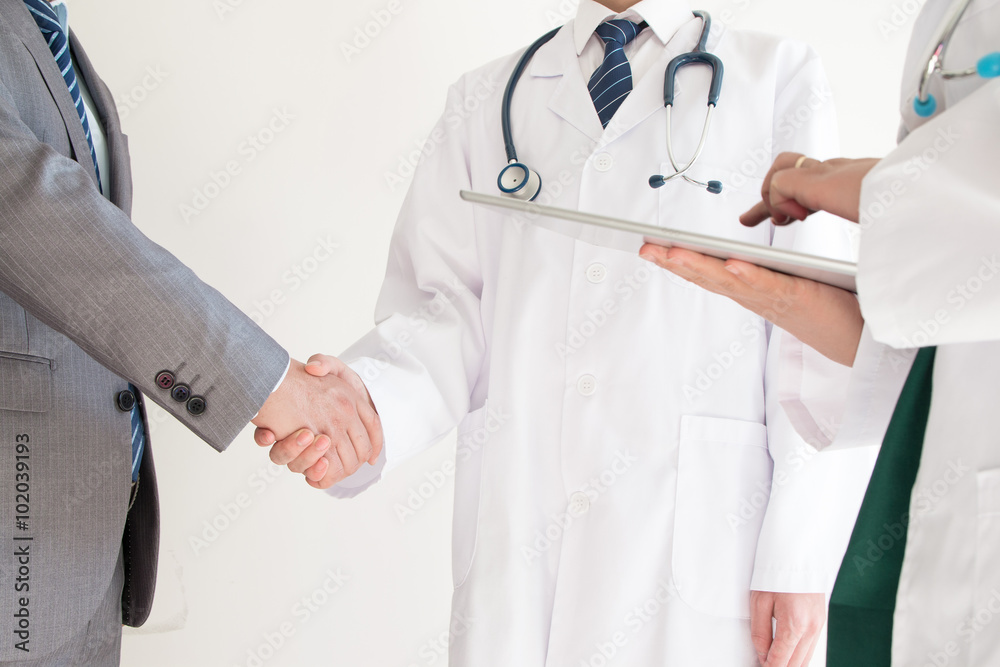 Doctor and businessman shaking hands Doctor and businessman shaking hands
