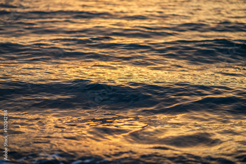 Sea surface with reflection at sunset. Selective focus.