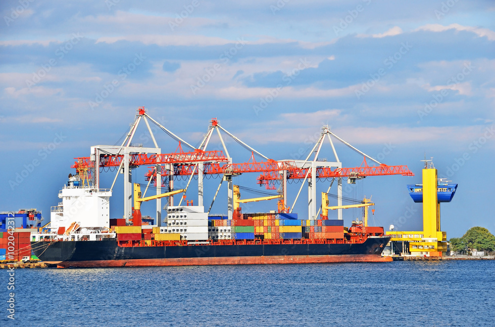 Container stack and ship under crane bridge