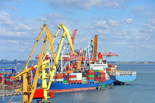 Container stack and cargo ship under crane bridge