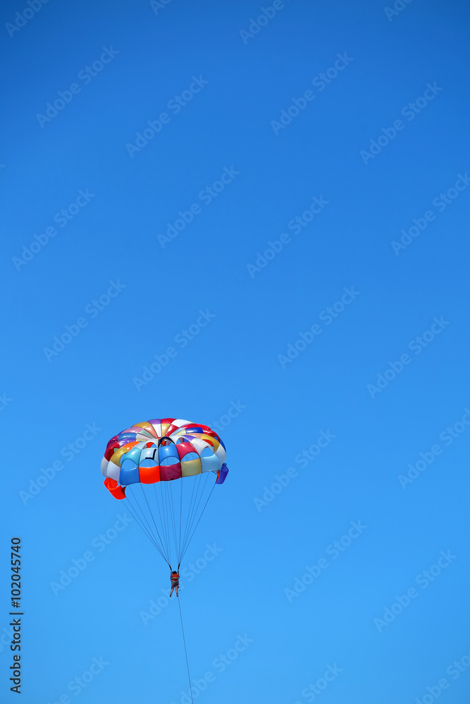 Parasailing girl against a blue sky Parasailing girl against a blue sky