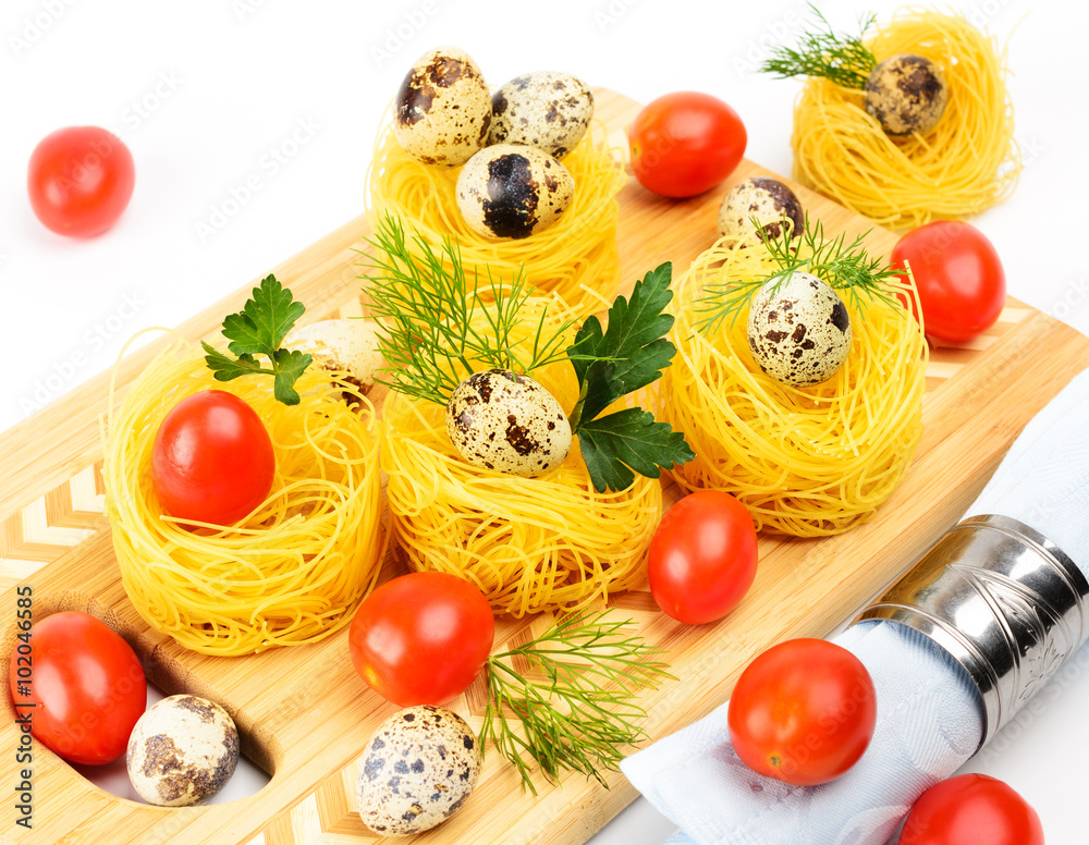 Pasta nests with cherry tomatoes and quail eggs. Pasta nests with cherry tomatoes and quail eggs.