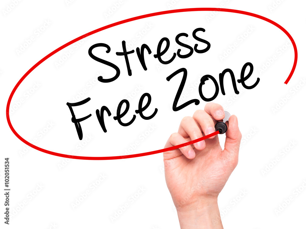 Man Hand writing Stress Free Zone with black marker on visual sc Man Hand writing Stress Free Zone with black marker on visual sc
