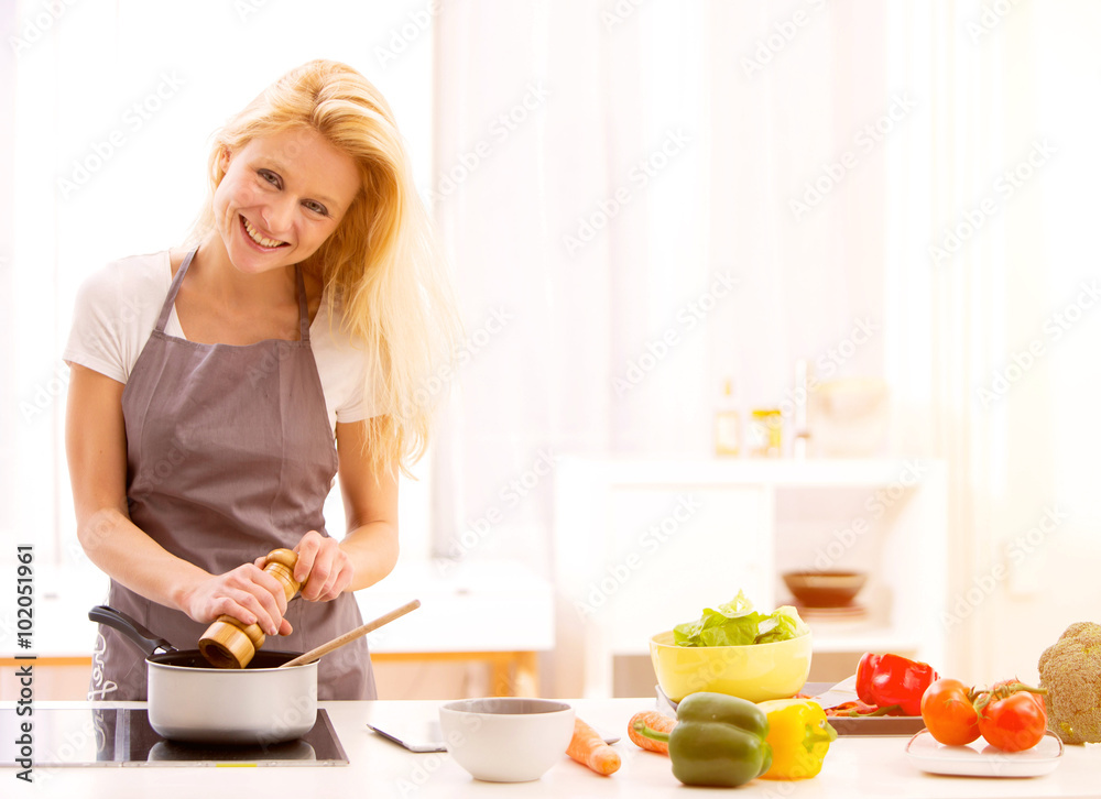 Young attractive woman cooking in a kitchen