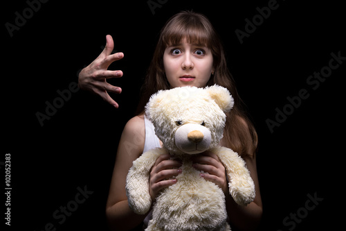 Scared teenage girl with toy