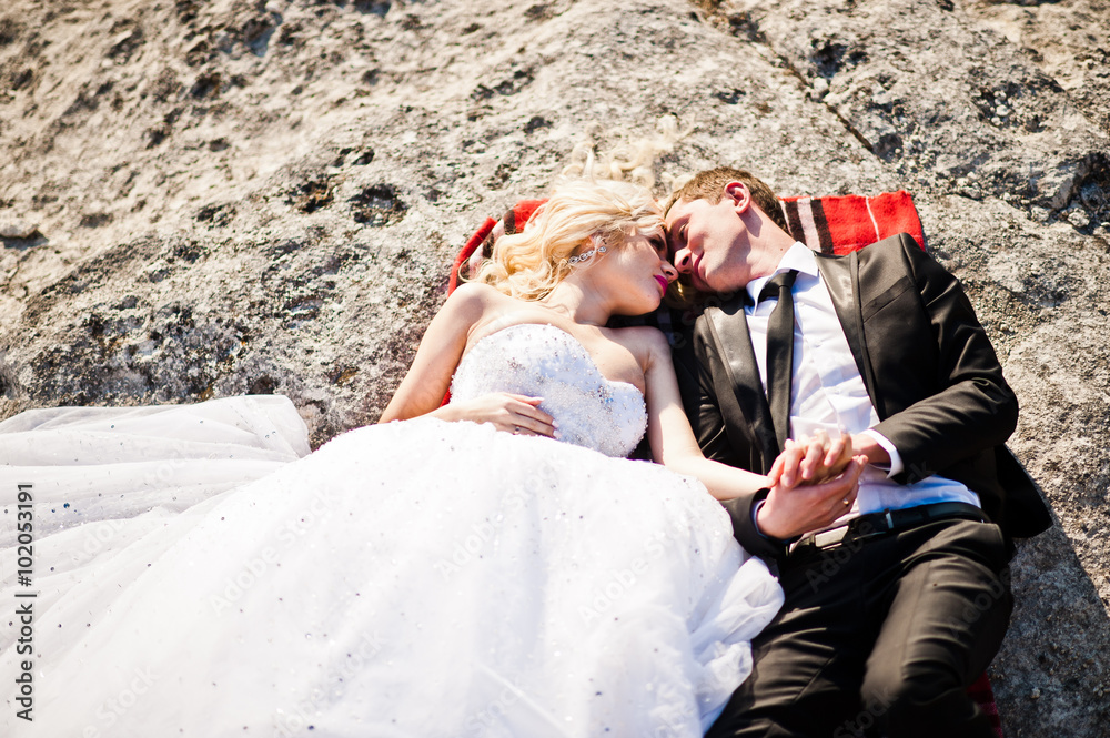 Charming bride and elegant groom on landscapes of mountains, lyi