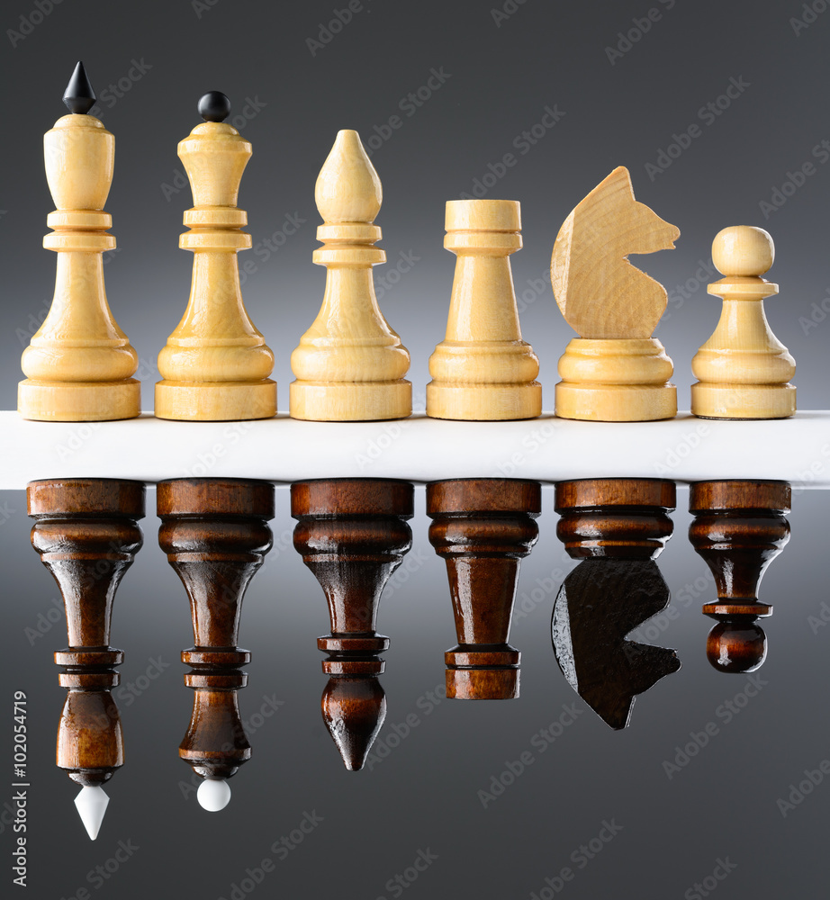 Black and white chess pieces on a table Black and white chess pieces on a table