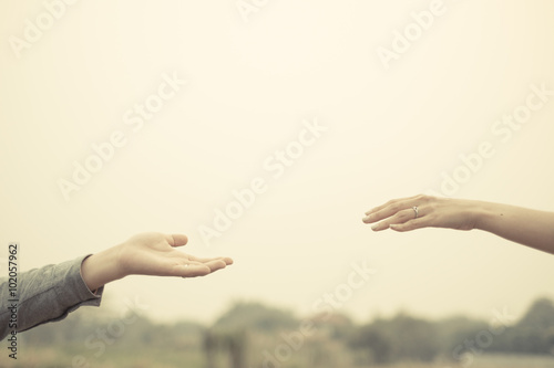 Couple hand together touch with love vintage filter tone.