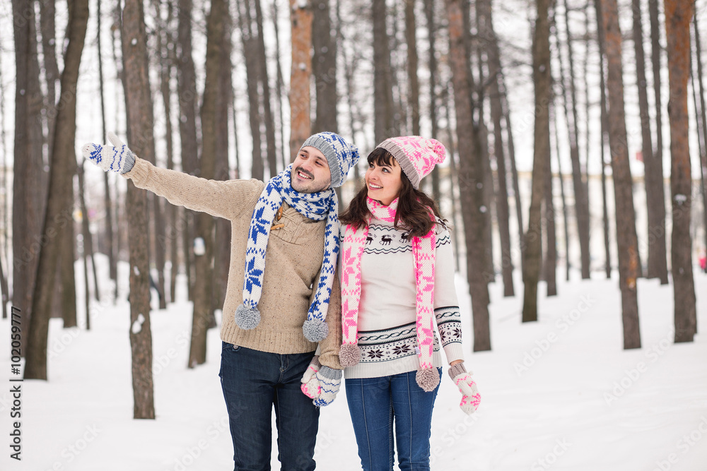 couple in love kissing in forest in winter sweaters. The guy ind