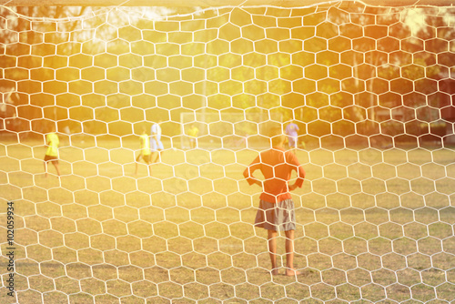 Soccer goal netting background childrenplaying soccer.process in vintage color tone photo