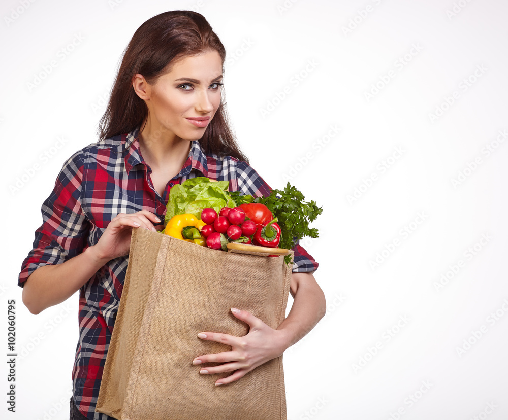 woman with groceries shopping bag full of healthy vegetables smi woman with groceries shopping bag full of healthy vegetables smi