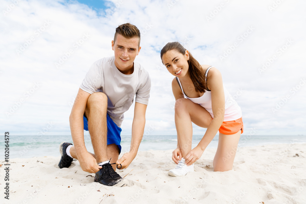 Fototapeta premium Runners lace their shoes and prepare to jogging