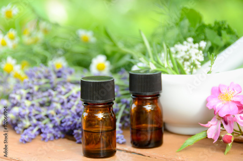 essential oils with herbs in garden spa