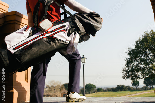 Golfer with his bag entering in a golf course