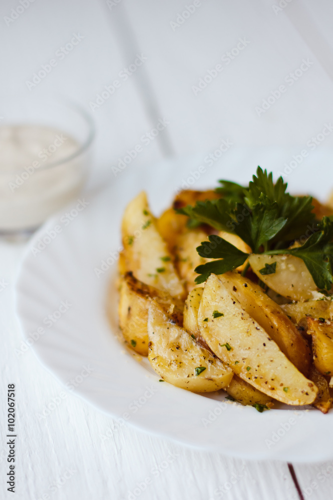beautiful roasted potatoes with herbs and spices on a white plate beautiful roasted potatoes with herbs and spices on a white plate