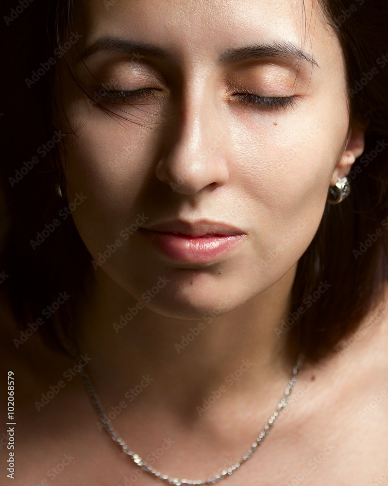 Portrait of young woman with closed eyes