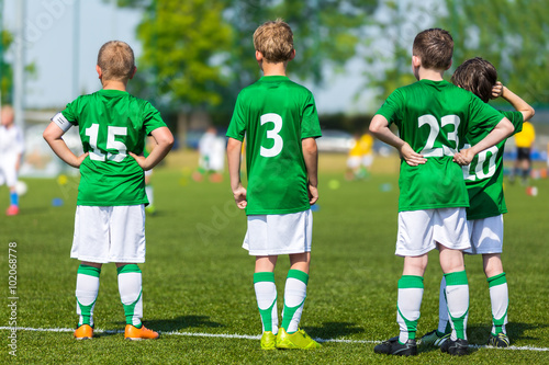 Group Of Children In Soccer Team Having Training. Youth Young Soccer Football Team on a Soccer Sport Field. Group of Boys Soccer Players Standing Together and Supporting Team