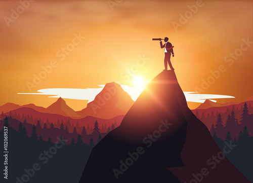 Businessman standing on top mountrain looking through binoculars 