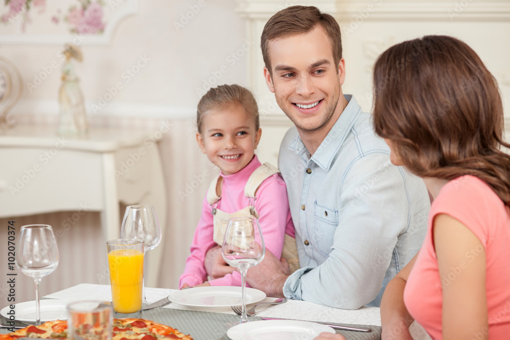 Cheerful married couple and child have a lunch