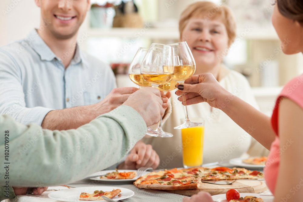 Cheerful relatives are dining together with joy