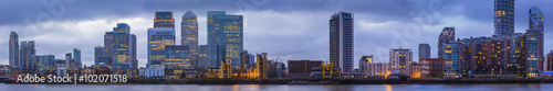 Wide panoramic skyline of Canary Wharf, the worlds leading financial district at blue hour - London, UK