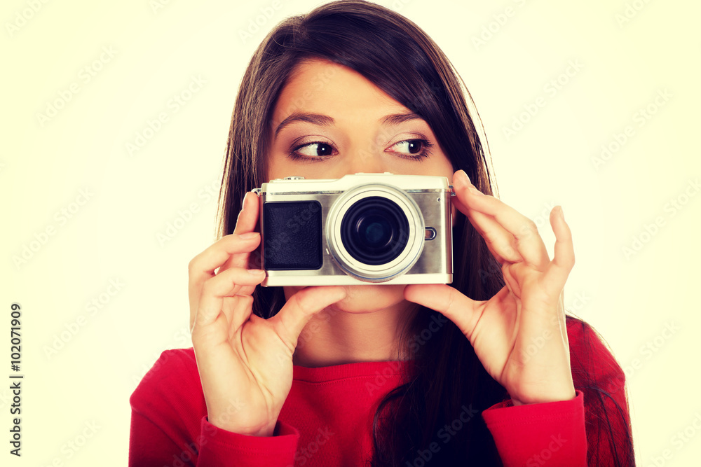 Woman taking a photo with a camera. Woman taking a photo with a camera.
