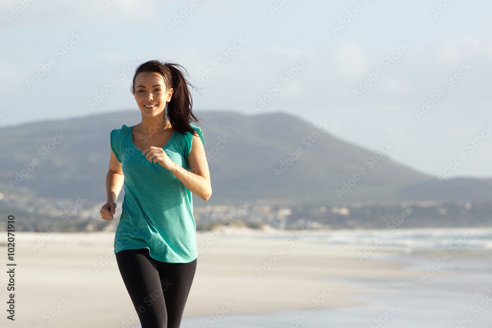 Attractive young lady running on the sea shore Attractive young lady running on the sea shore